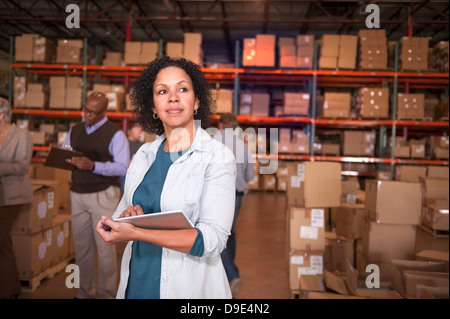 Female warehouse worker using digital tablet Stock Photo