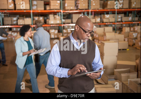 Male warehouse manager using digital tablet Stock Photo