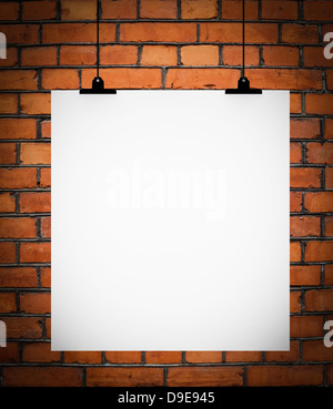 Blank board hanging on brick wall Stock Photo