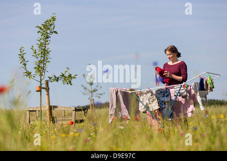 Washing line with drying clothes in outdoor. Clothes hanging on washing line  in outdoor Stock Photo - Alamy