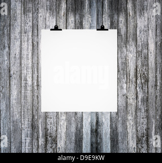 Blank paper board hanging on grunge wooden wall Stock Photo