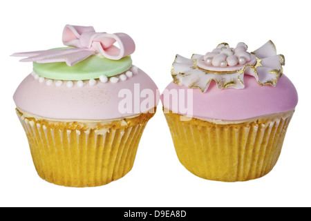 Two iced cupcakes in pink, white, blue and gold isolated on white. Stock Photo
