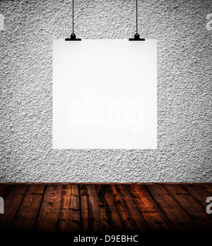 Interior of grunge empty room with white paper hanging on paper clips Stock Photo