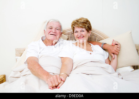 happy senior couple in bed relaxing Stock Photo