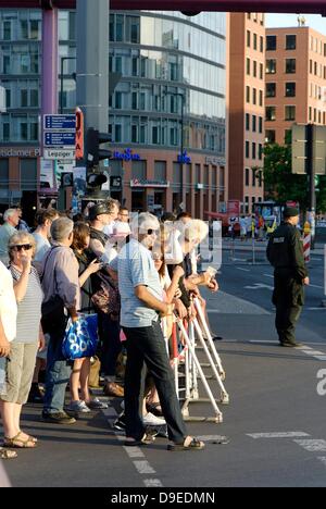 Berlin, Germany. 18th June 2013. The highest level of security is in place during the visit of the American President Obama in Berlin. Around the Potsdamer Platz a barrier was erected. Spectators try to get a look at what is happening. Credit:  Marcus Krauss/Alamy Live News Stock Photo