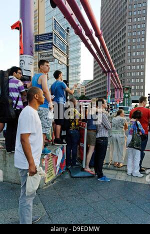 Berlin, Germany. 18th June 2013. The highest level of security is in place during the visit of the American President Obama in Berlin. Around the Potsdamer Platz a barrier was erected. Spectators try to get a look at what is happening. Credit:  Marcus Krauss/Alamy Live News Stock Photo