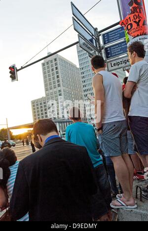 Berlin, Germany. 18th June 2013. The highest level of security is in place during the visit of the American President Obama in Berlin. Around the Potsdamer Platz a barrier was erected. Spectators try to get a look at what is happening. Credit:  Marcus Krauss/Alamy Live News Stock Photo