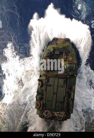 An amphibious assault vehicle exits the well deck of USS Essex. Stock Photo