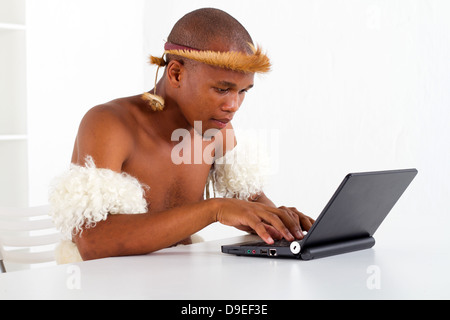 traditional African tribal man learning computer Stock Photo