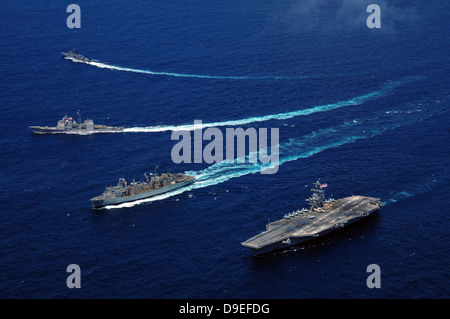 The USS Bunker Hill, the USNS Rainier, and the BAP Carvajal break away from the aircraft carrier USS Carl Vinson at sea. Stock Photo