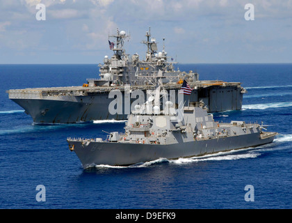 Amphibious assault ship USS Nassau and guided missile destroyer USS Bulkeley transit the Atlantic Ocean. Stock Photo