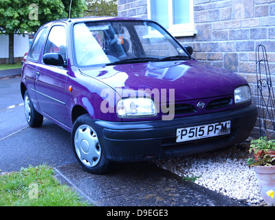Small old Purple Nissan Micra, as used by a young driver, May 2013 Stock Photo