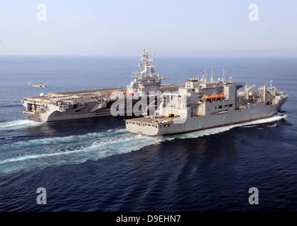 The Military Sealift Command dry cargo and ammunition ships conduct a vertical replenishment. Stock Photo