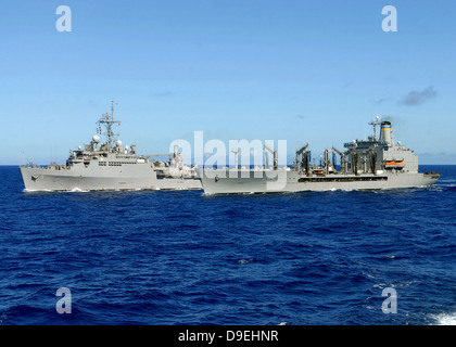 USS Denver and USNS Pecos conduct a replenishment at sea. Stock Photo
