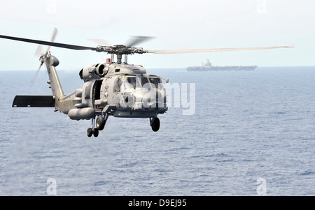 An MH-60R Seahawk helicopter in flight over the Pacific Ocean