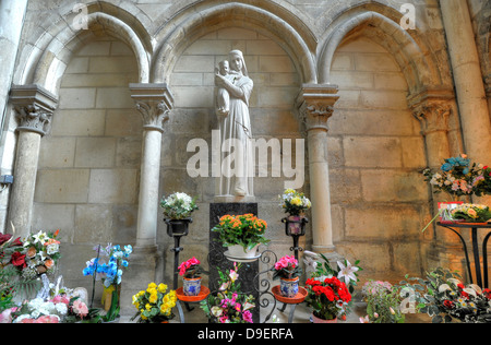Flowers before statue virgin Maria and Jesus' child, side altar, abbey church Saint-Remi Wed. basilica, UNESCO world cultural h Stock Photo