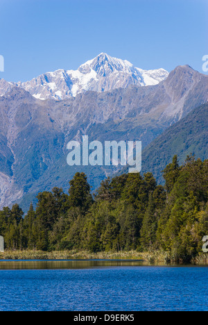 Aoraki/Mount Cook (3754m) is the highest mountain in New Zealand and is seen here from Lake Matheson, near Fox Glacier. Stock Photo