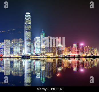 Hong Kong skyline at Victoria Harbor with reflections. Stock Photo