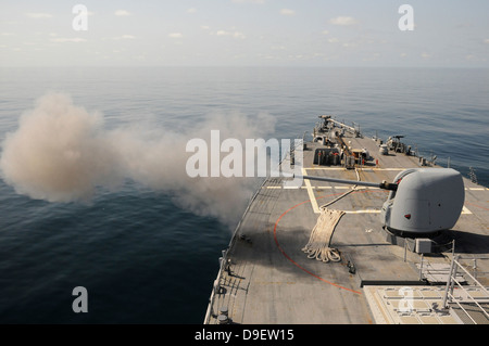 An Mk-45 lightweight gun is fired aboard guided missile destroyer USS Mitscher Stock Photo