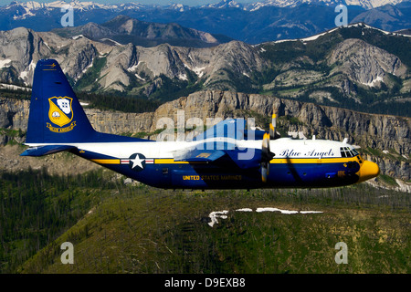 A C-130 Hercules Fat Albert plane flies over the Chinese Wall rock formation in Montana. Stock Photo