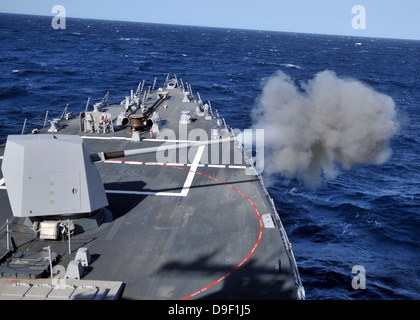 The MK-45 lightweight gun is fired aboard USS Halsey. Stock Photo