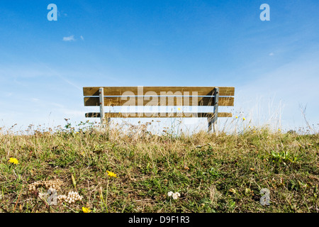 Desolate wooden bank on a dyke Abandoned wooden bench on a dike Stock Photo