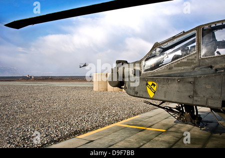 An AH-64D Apache helicopter comes in for a landing at a military base in Afghanistan. Stock Photo