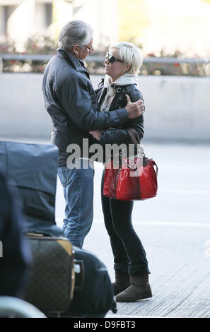 George Hamilton says goodbye to girlfriend Barbara Sturm Celebrities arrive at LAX to catch departing flights after attending the 83rd Annual Academy Awards (Oscars) Los Angeles, California Stock Photo