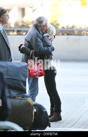 George Hamilton says goodbye to girlfriend Barbara Sturm Celebrities arrive at LAX to catch departing flights after attending the 83rd Annual Academy Awards (Oscars) Los Angeles, California Stock Photo