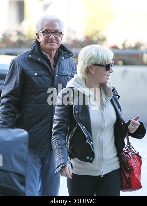 George Hamilton says goodbye to girlfriend Barbara Sturm Celebrities arrive at LAX to catch departing flights after attending the 83rd Annual Academy Awards (Oscars) Los Angeles, California Stock Photo