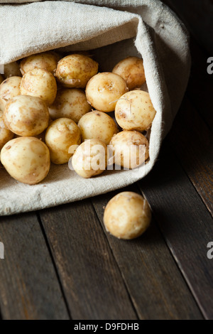 new potatoes in a linen sack, fresh food Stock Photo