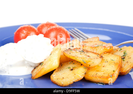 Fried potatoes with tomatoes and curd on a plate Fried potatoes with tomato and cottage cheese on a plate Stock Photo