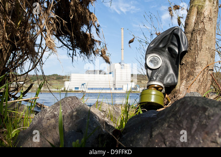 An old gas mask with the nuclear power plant Kruemmel in the background Stock Photo