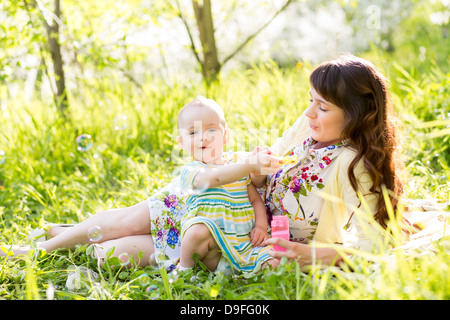 mother and baby girl having fun outdoors Stock Photo