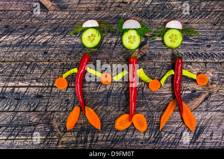 Composition with early vegetables on wooden board Stock Photo