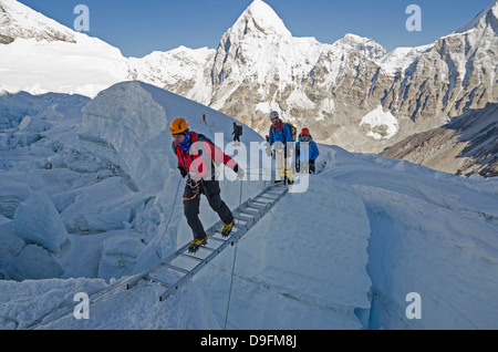 Crossing ladders in the Khumbu icefall on Mount Everest, Sagarmatha National Park, UNESCO World Heritage Site, Nepal, Himalayas Stock Photo