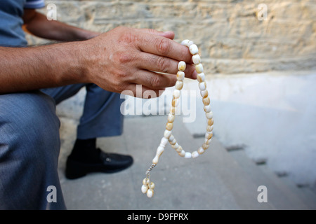Man holding prayer beads, Baku, Azerbaijan, Central Asia Stock Photo