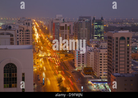 City skyline and Rashid Bin Saeed Al Maktoum Street at dusk, Abu Dhabi, United Arab Emirates, Middle East Stock Photo