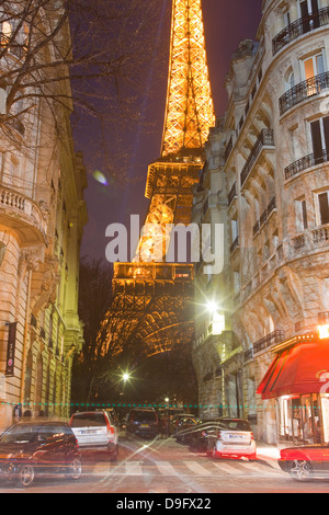 The iconic Eiffel Tower lit up at dusk in central Paris, France