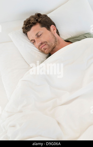 Man sleeping on the bed Stock Photo