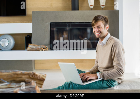 Portrait of a smiling man using a laptop Stock Photo