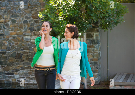 Two female friends smiling together Stock Photo