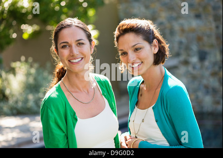 Two female friends smiling together Stock Photo