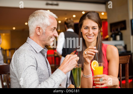 Couple enjoying drinks in a restaurant Stock Photo