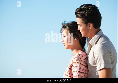 Romantic couple standing together and smiling Stock Photo
