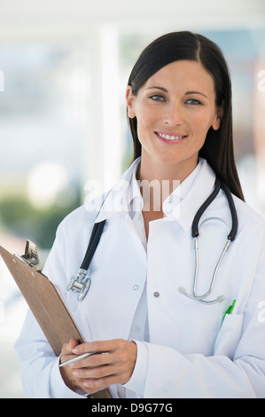 Female doctor holding a clipboard and smiling Stock Photo