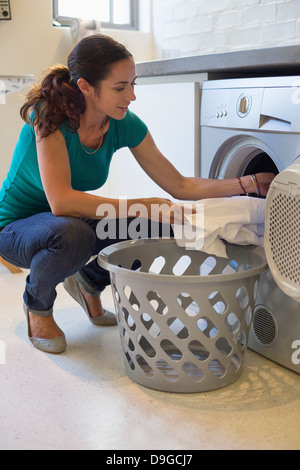 Woman doing laundry at home Stock Photo