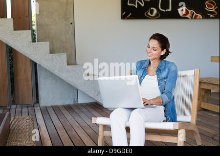 Woman doing online chatting on a laptop Stock Photo