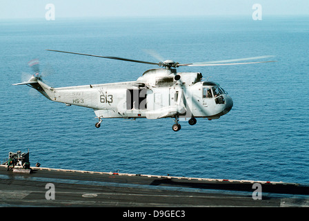 An SH-3H Sea King helicopter prepares to land on USS Saratoga. Stock Photo