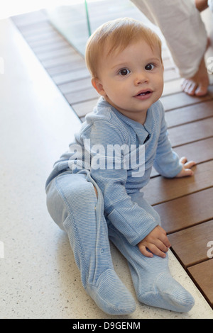 Portrait of a baby boy sitting on the floor Stock Photo